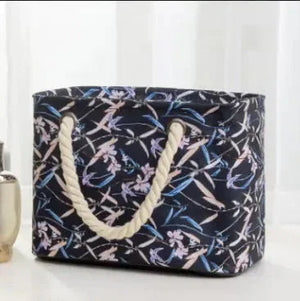 Floral canvas tote bag with rope handles on light background
