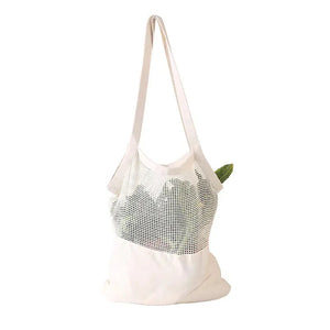 White mesh reusable tote bag with long handles and vegetables inside