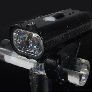 Water-resistant black LED bike headlight mounted on bicycle handlebar