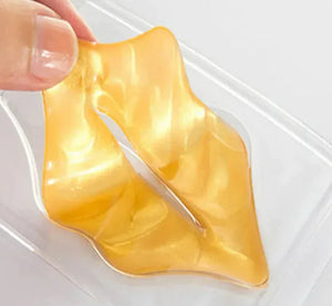 Hand holding gold hydrogel lip mask for moisturizing lip care