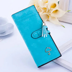 Turquoise women's wallet with umbrella charm and tassel, displayed on white background