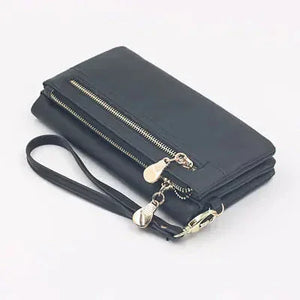 Black leather wallet with wrist strap and gold zipper, minimalist clutch design