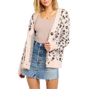 Woman wearing a leopard print cardigan, beige tank top, and denim mini skirt