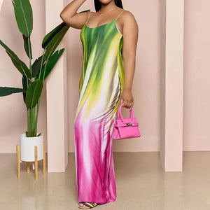 Woman wearing sleeveless ombre maxi dress in green, yellow, and pink holding pink handbag