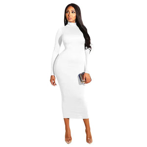 Woman in fitted white long sleeve turtleneck midi dress holding a clutch bag