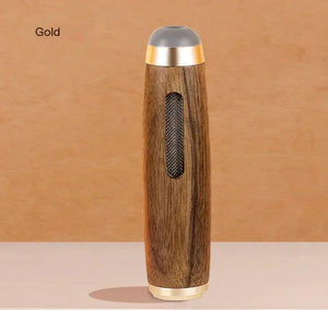 Wood grain spice grinder with gold accents on neutral background