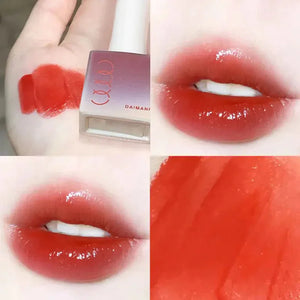 Glossy red lip tint swatch on hand and lips, showing vibrant, smooth makeup finish.