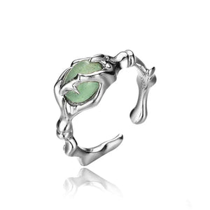 Sterling silver open ring with claw design and green stone accent