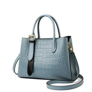 Light blue crocodile-embossed leather handbag with top handles and gold hardware