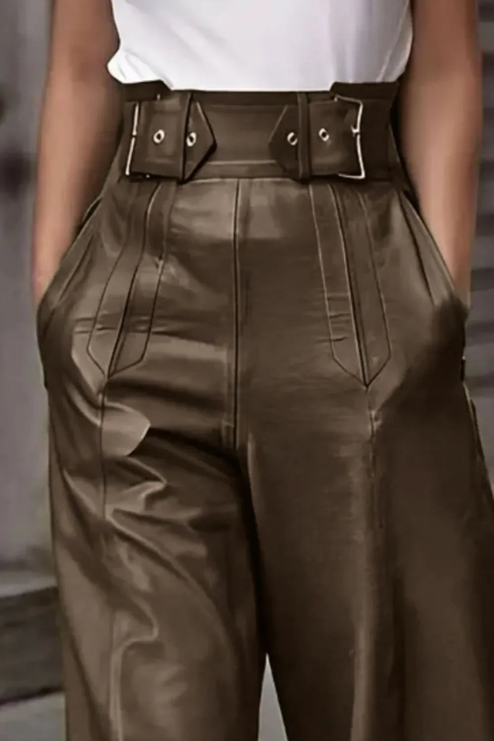 High-waisted brown faux leather pants with belt detail and deep pockets