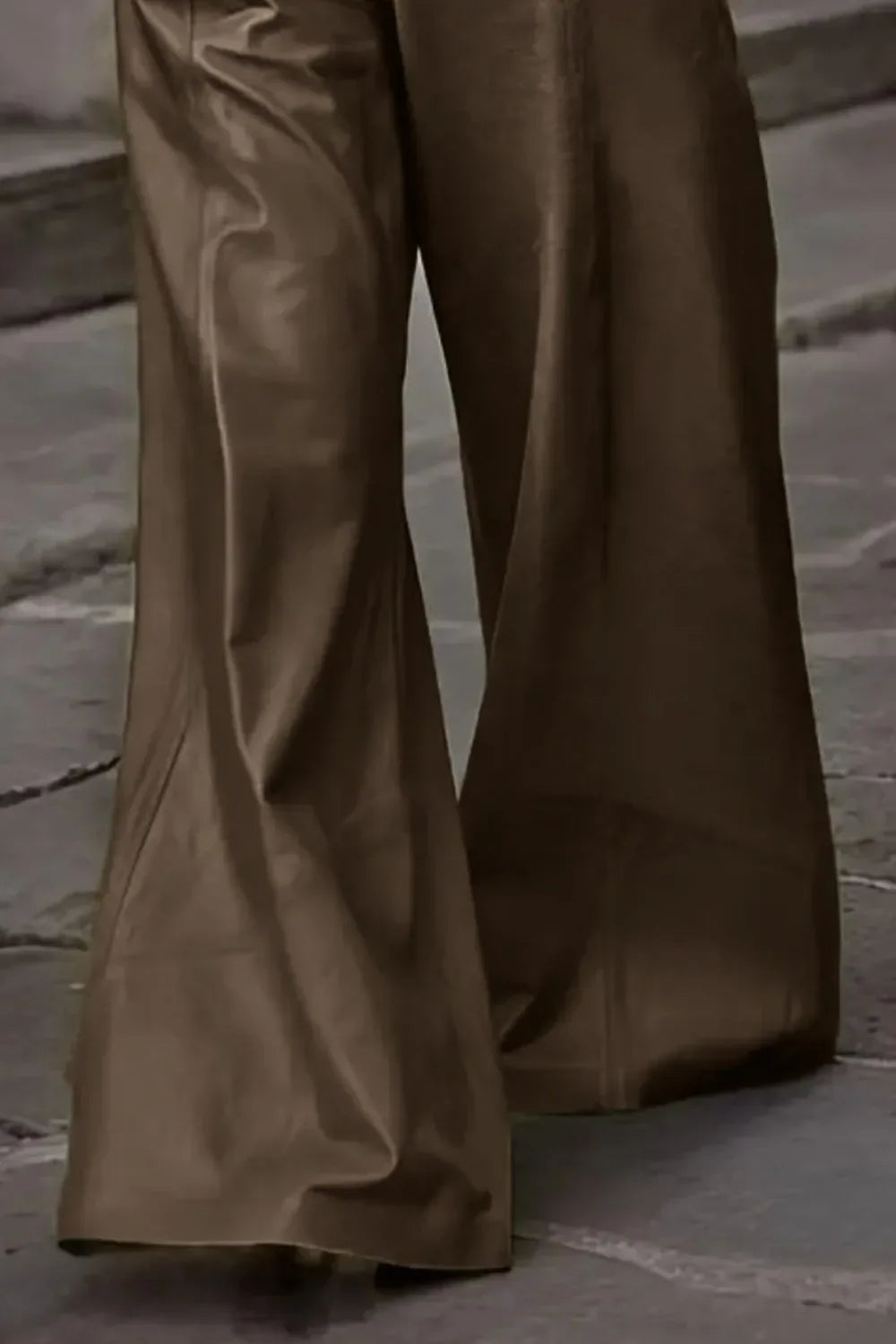 Brown wide-leg pants with a smooth, flowy fabric, shown on a stone pavement
