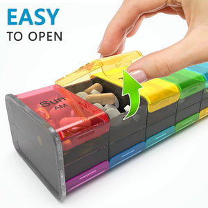 Hand opening colorful weekly pill organizer filled with capsules and tablets