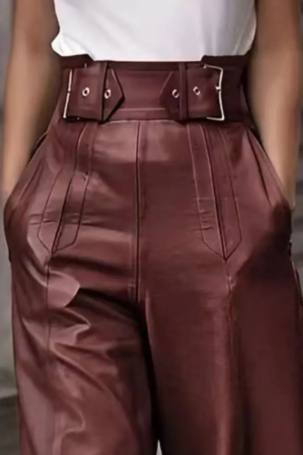 High-waisted brown faux leather pants with wide belt and buckle details