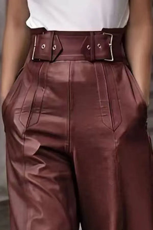 High-waisted brown faux leather pants with wide belt and buckle details