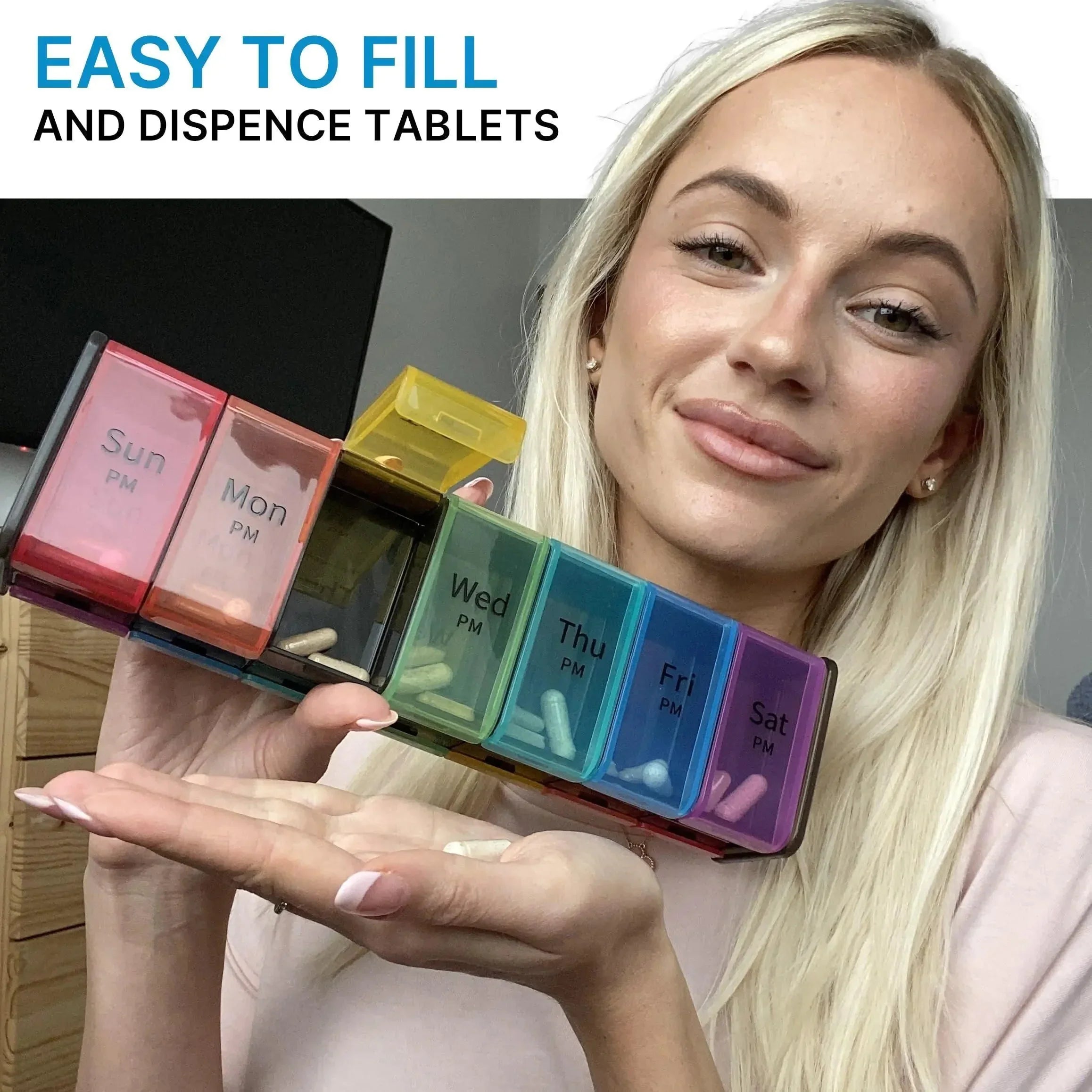 Woman holding colorful weekly pill organizer with labeled compartments for each day.
