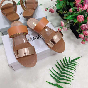 Brown and gold metallic flat sandals on display box, with floral background, women's fashion footwear